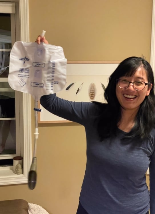 Mimi Lan holding a urine collection device, similar to the one aboard SpaceX's Polaris Dawn mission.